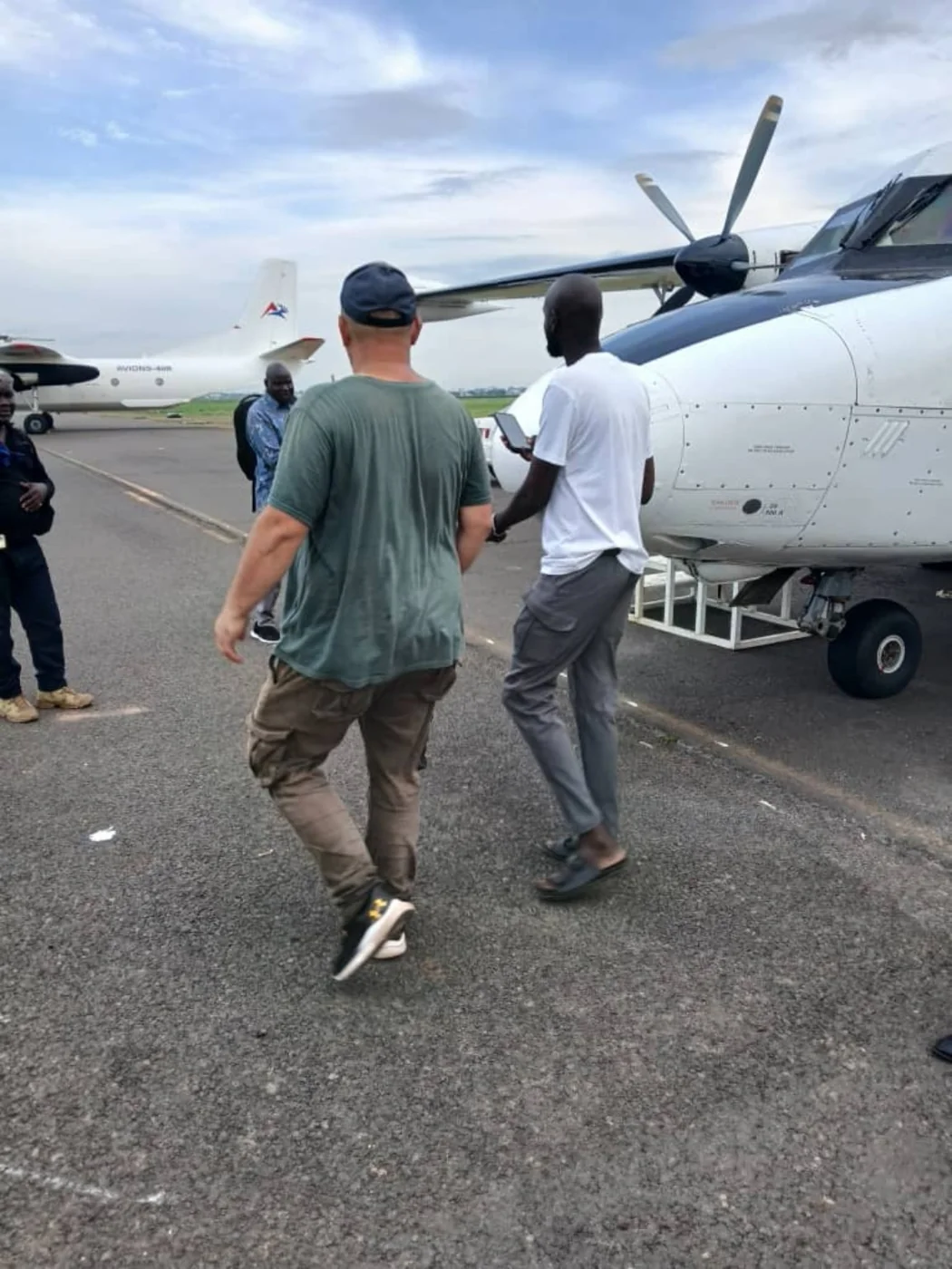 Delmark team members carrying out airport operations beside an aircraft