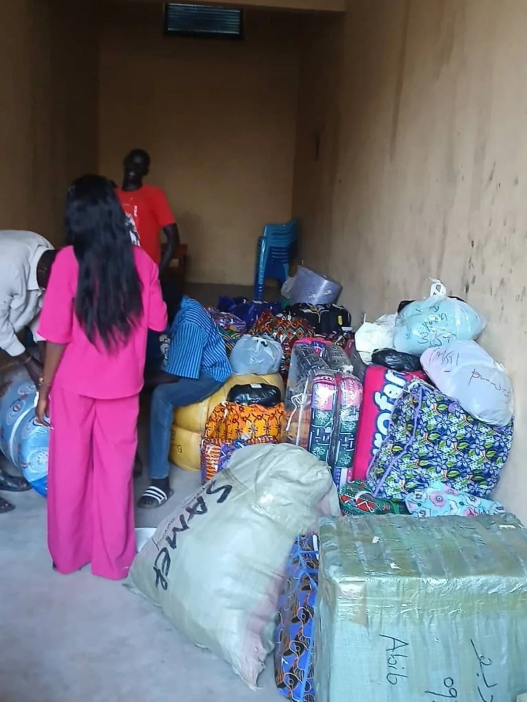 Delmark staff members and customers gathered around a room with cargo